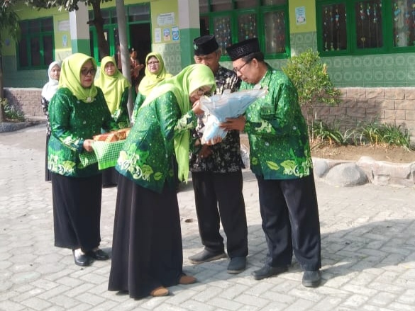 TAKDZIM. Para guru memberikan hormat dengan penuh rasa takdzim kepada Ustadz Bahri, seorang guru sepuh yang sudah mengabdi selama setengah abad di MI Sabilul Mubtadiin Randegansari Driyorejo Gresik. Foto: dok MI Sabilul Mubtadiin Randegansari/NUGres